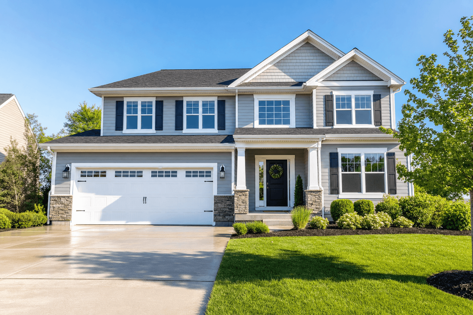 Professionally cleaned home exterior with sparkling windows and fresh driveway by Elite Exterior Care